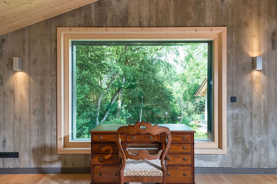 Home workspace with a classic desk and chair and a window that offers panoramic views