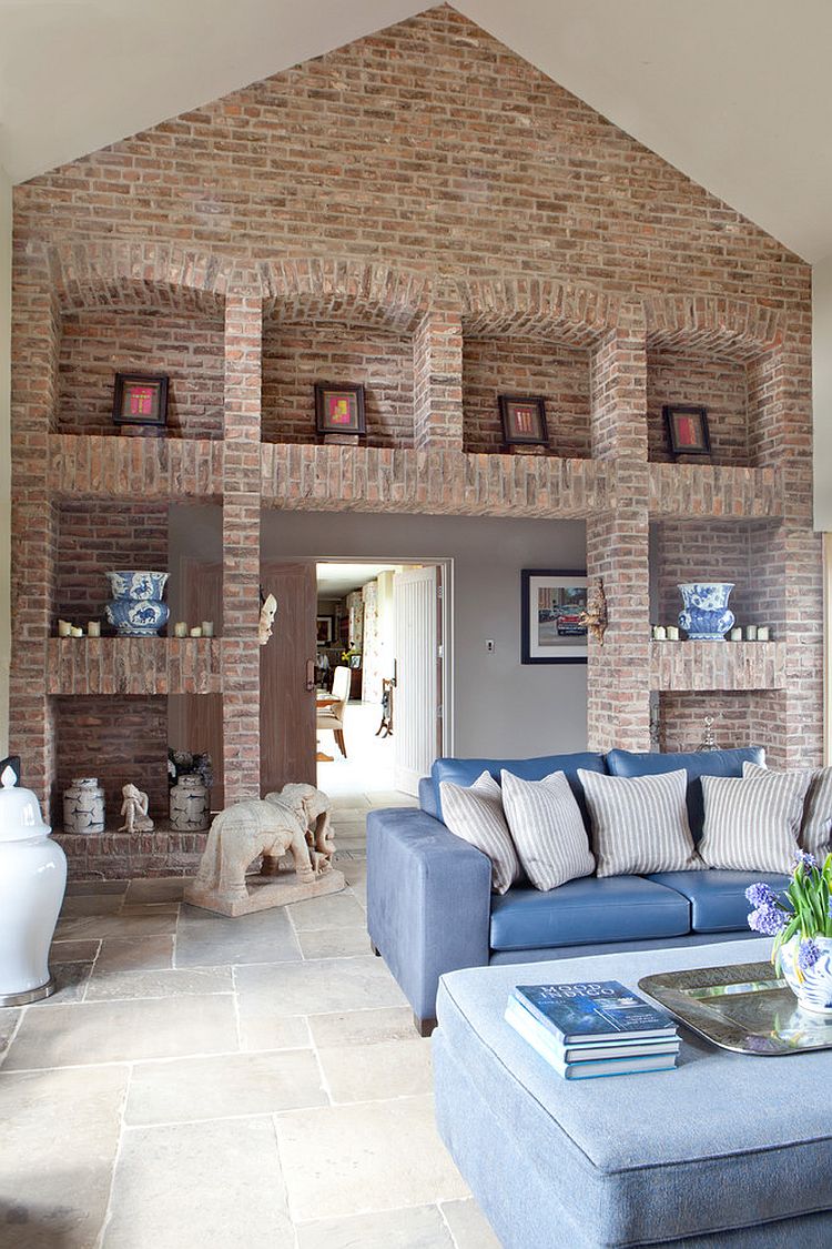 Imposing brick walls and shelves set the tone in this living room [Design: Carolyn Parker Interior Design]