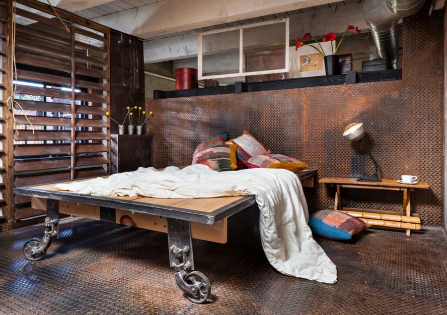 Industrial bedroom with metal flooring and walls