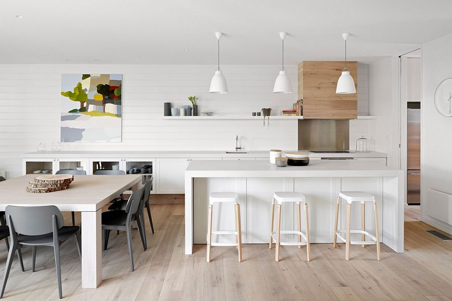 Kitchen and dining area of the Aussie beach house with a neutral color scheme and lovely wall art