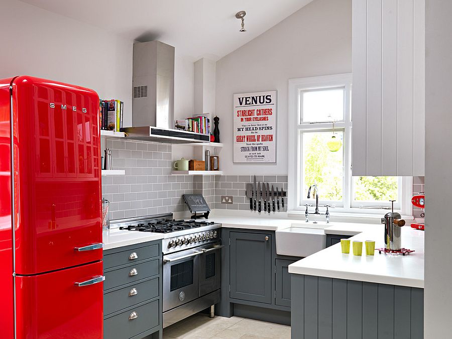 Kitchen cabinets in Mercury by Fired Earth complement the splash of red!