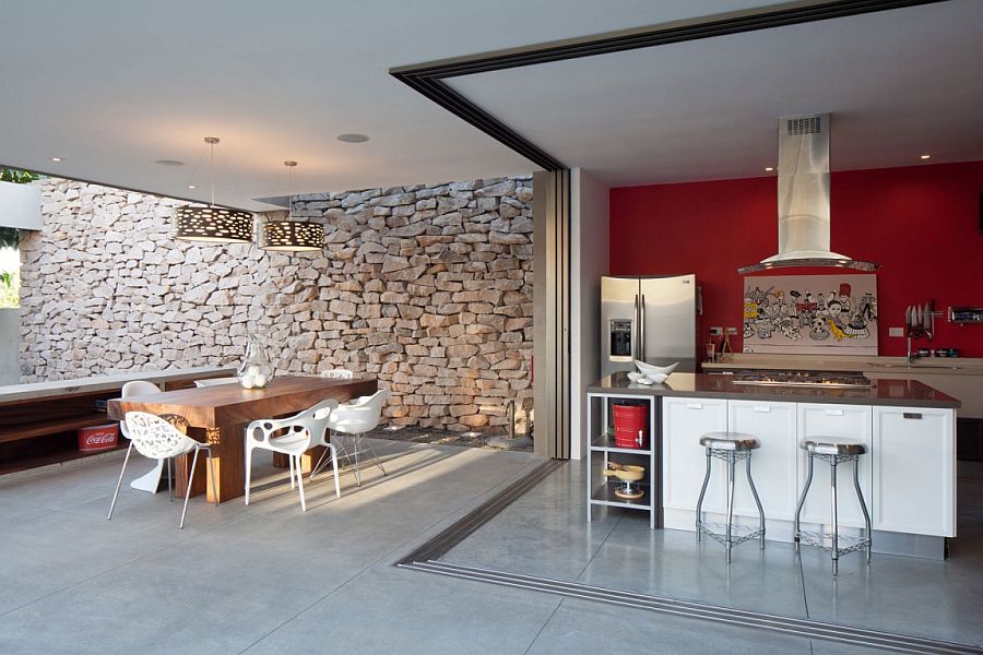 Kitchen, dining and entertaining zone of the house with a stone backdrop