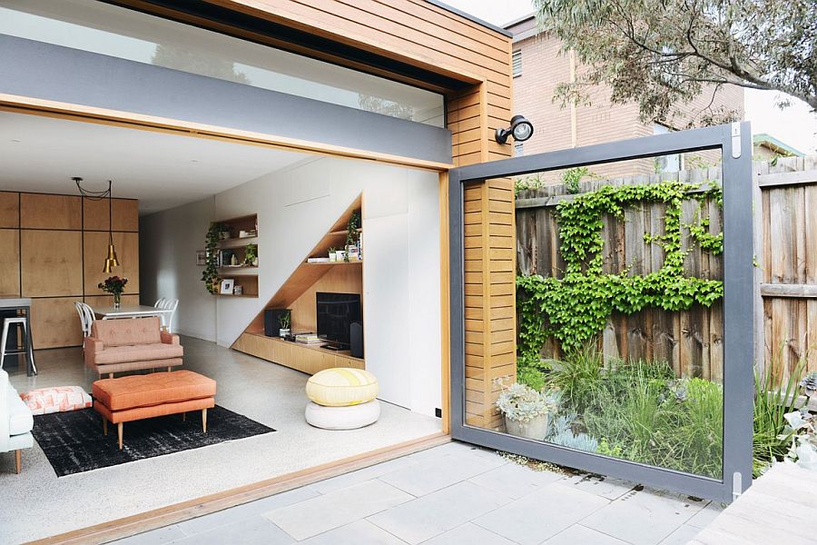 Large glass door connects the living area indoors with the rear yard