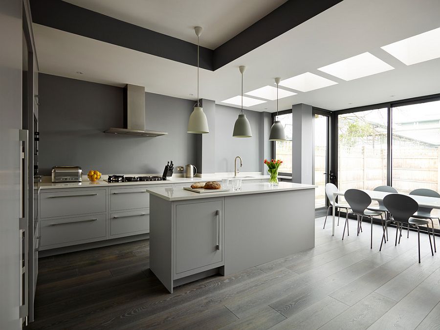 Lighting and flooring create a fusion between the various shades of gray in the kitchen