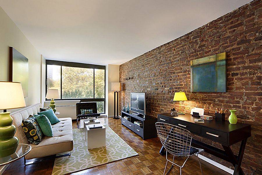 Living room of New York home proudly showcases original brick wall [Design: Designed To Appeal]
