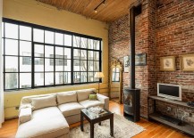 Living-room-with-freestanding-fireplace-large-window-and-brick-walls-217x155