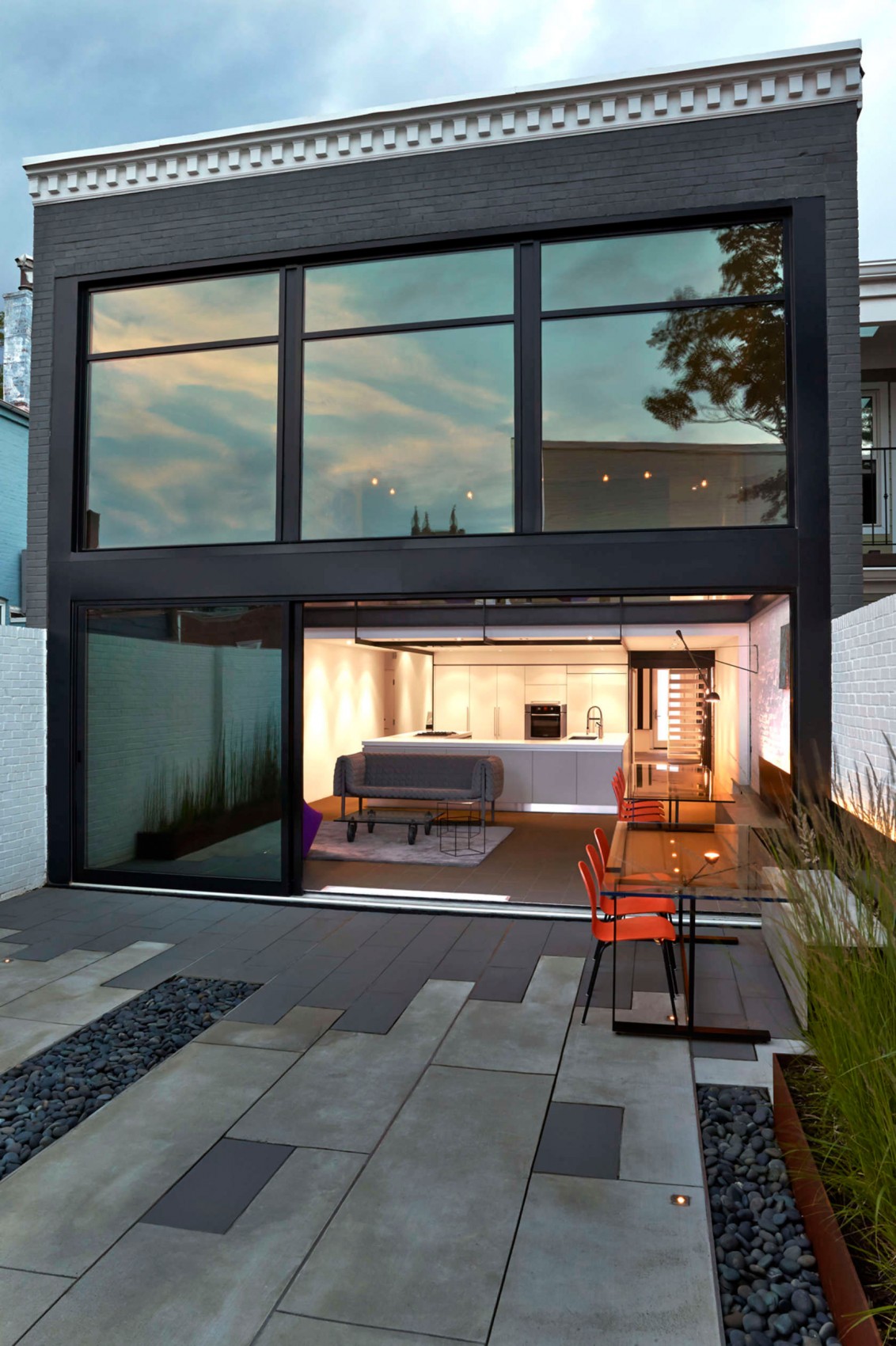 Massive glass windows and sliding doors open up the rear to the garden