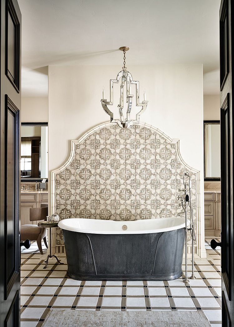 Mediterranean bathroom with pewter bathtub backed and an elegant tile wall [Design: Wiseman & Gale Interiors]