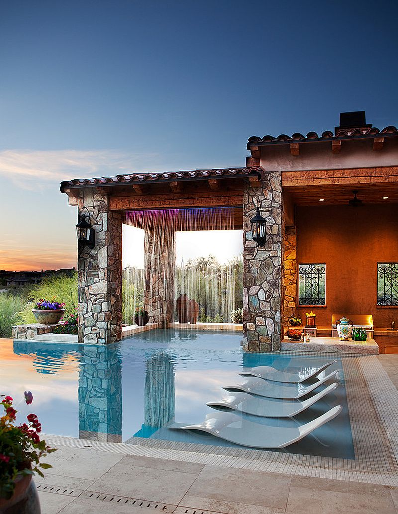 Mediterranean style pool area with waterfall features a hidden wonder