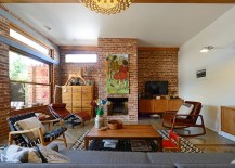 Midcentury-living-room-with-brick-walls-and-oversized-artwork-above-fireplace-217x155