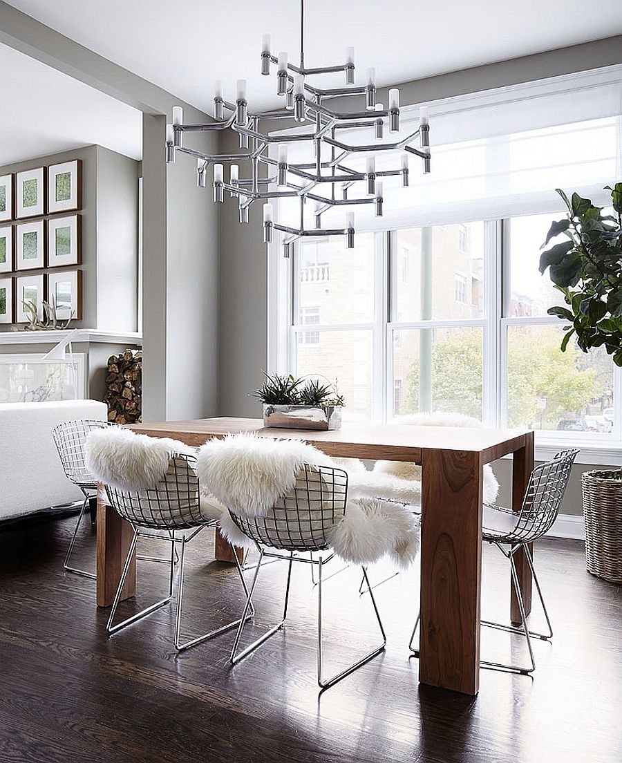 Minimal dining room table, smart chandelier and plush textures shape a stunning dining room
