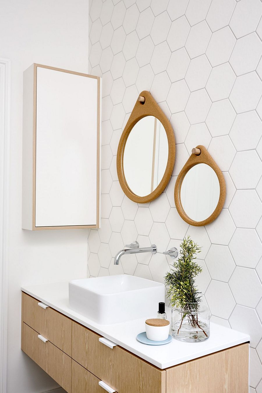 Mirror frames and vanity bring elegance to the white bathroom