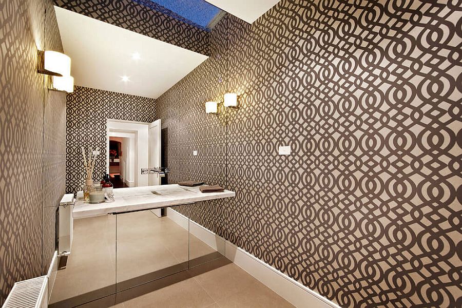 Mirrored wall and wallpaper create a spacious look in the bathroom