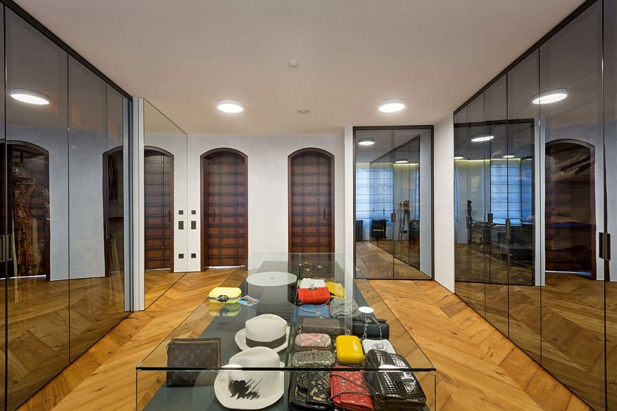 Mirrored wardrobe doors and a central island for the lavish walk-in closet