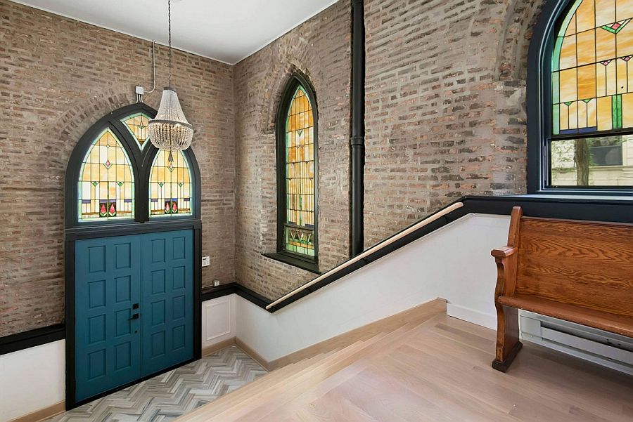 Original stained glass windows and exposed brickwork of the renovated church home