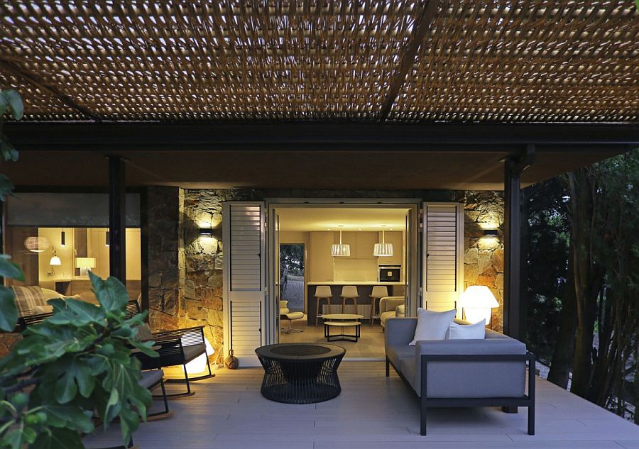 Outdoor sitting zone of the elegant Spanish home under the wicker pergola