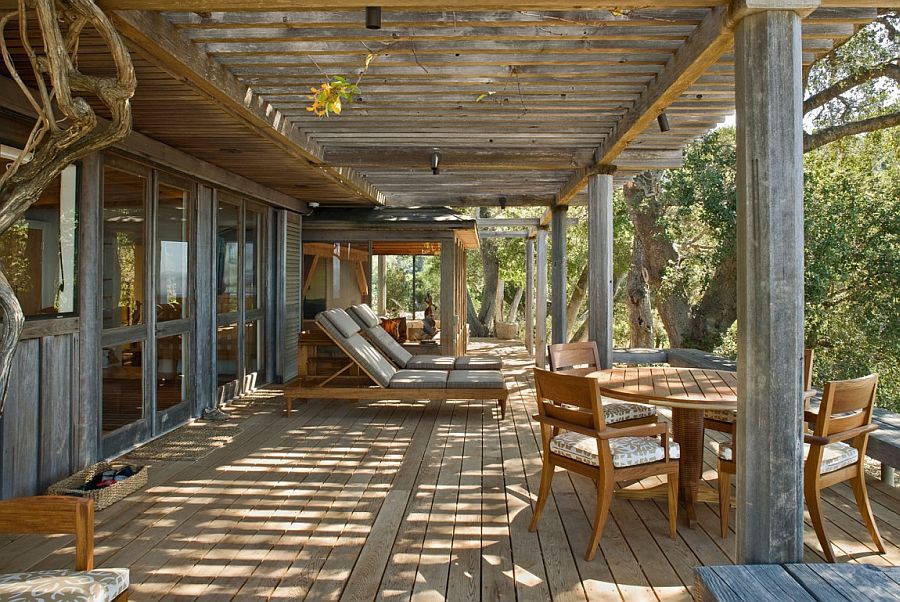 Pergola structure and natural canopy offer ample shade for the outdoor lounge