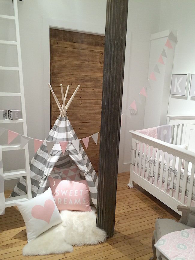 Pink, white, and gray teepee in a little girl's nursery