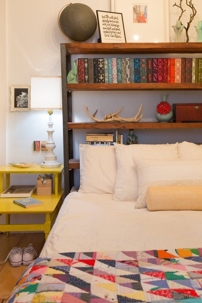 A Wall In This Bedroom Was Fully Built-In With Shelving, Headboard