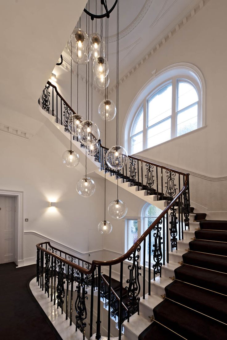 Plain glass pendant lighting hanging over a staircase