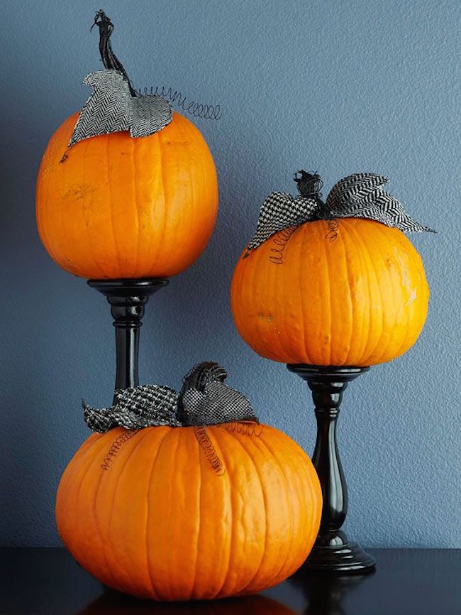 Plain pumpkins with ribbon and candlesticks