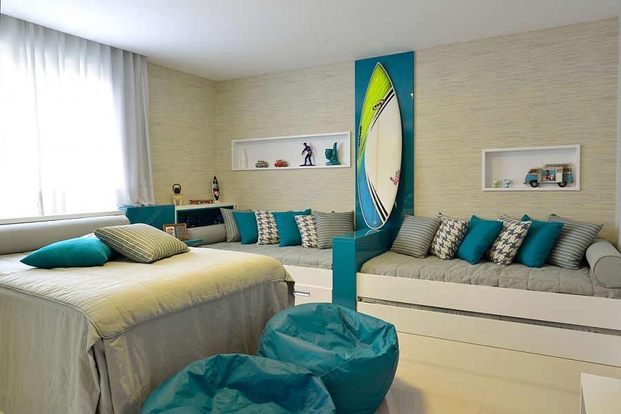 Plush daybeds and surfboard on the wall for the coastal style bedroom