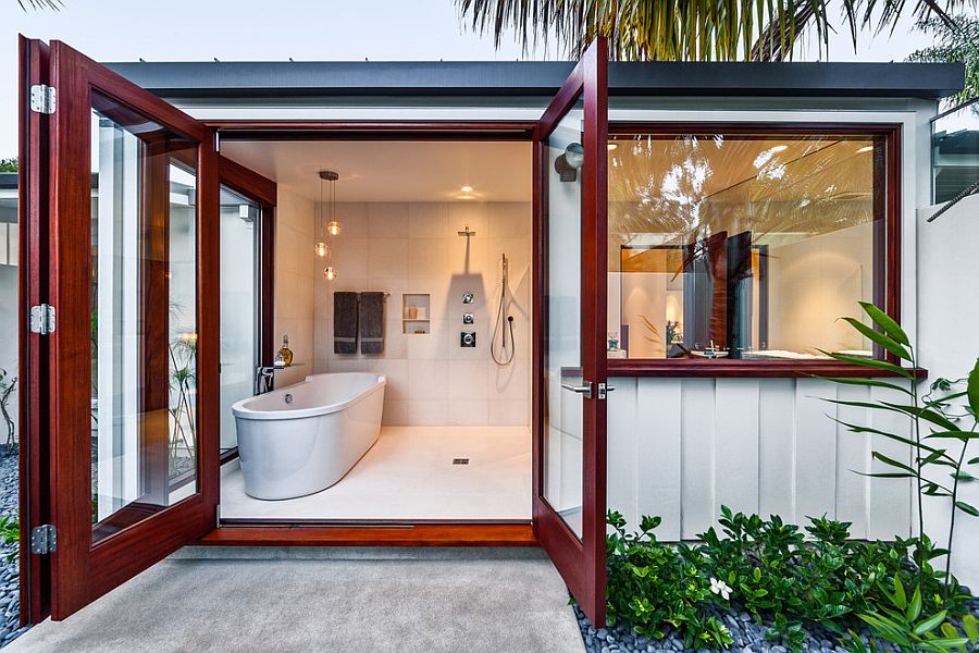 Relaxing bathroom with standalone bathtub opens up into the landscape outside