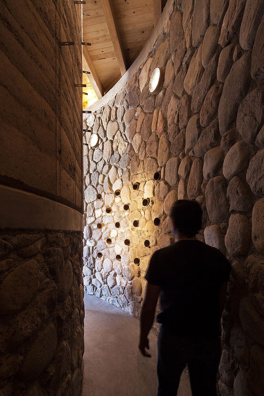 River rocks, pine wood, rammed earth and concrete shape the fabulous Pilares retreat