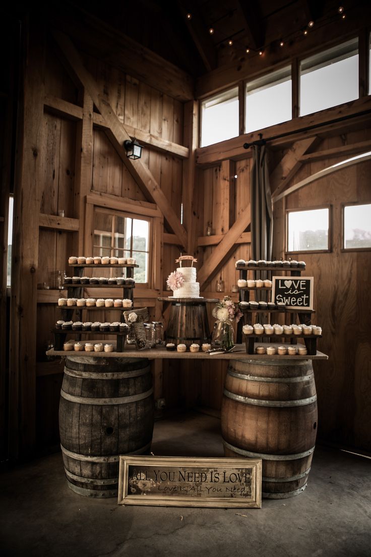 Rustic wedding table display using wine barrels