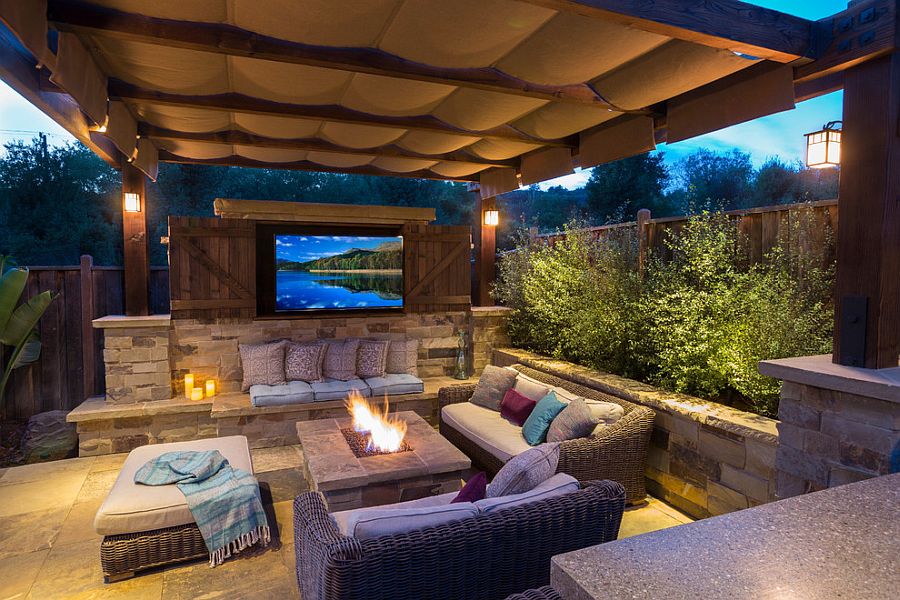 Shade sail above the pergola offers protection from the elements [Design: John Benson Photography]