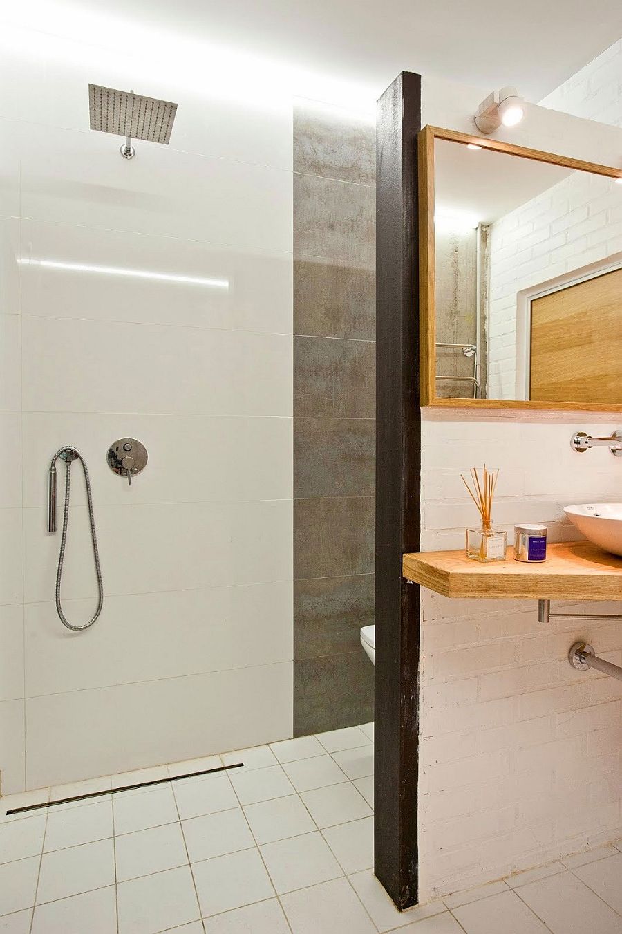 Shower area of the small bathroom in tile and concrete