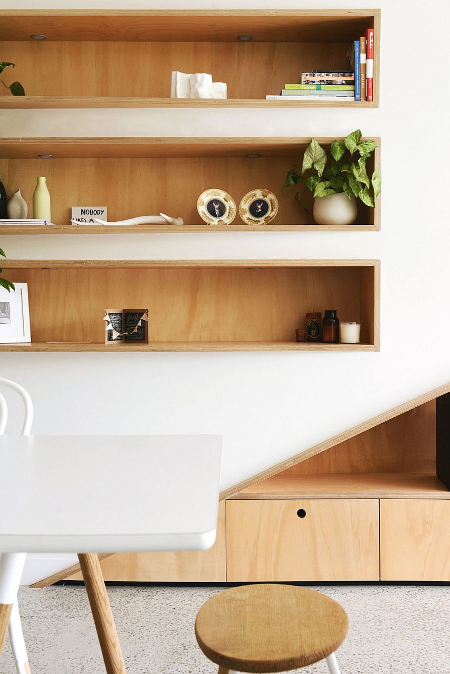 Simple shelves in the living room clad in wood