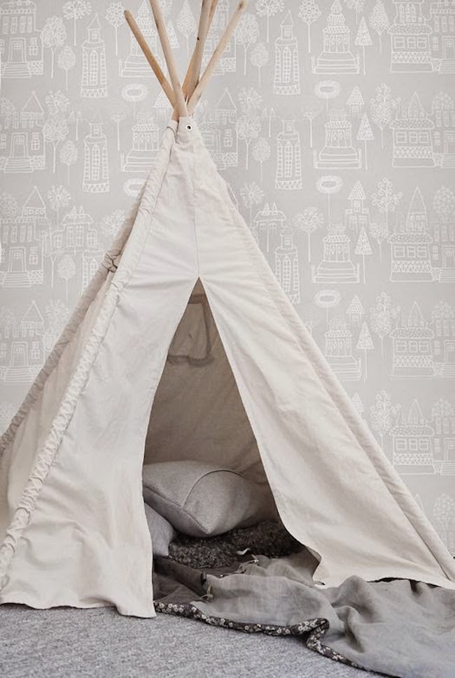 Simple white teepee with gray pillows and blankets