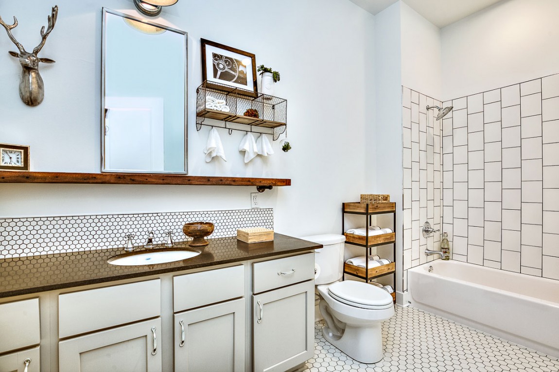 Sleek floating shelf in wood brings personality to the breezy bathroom