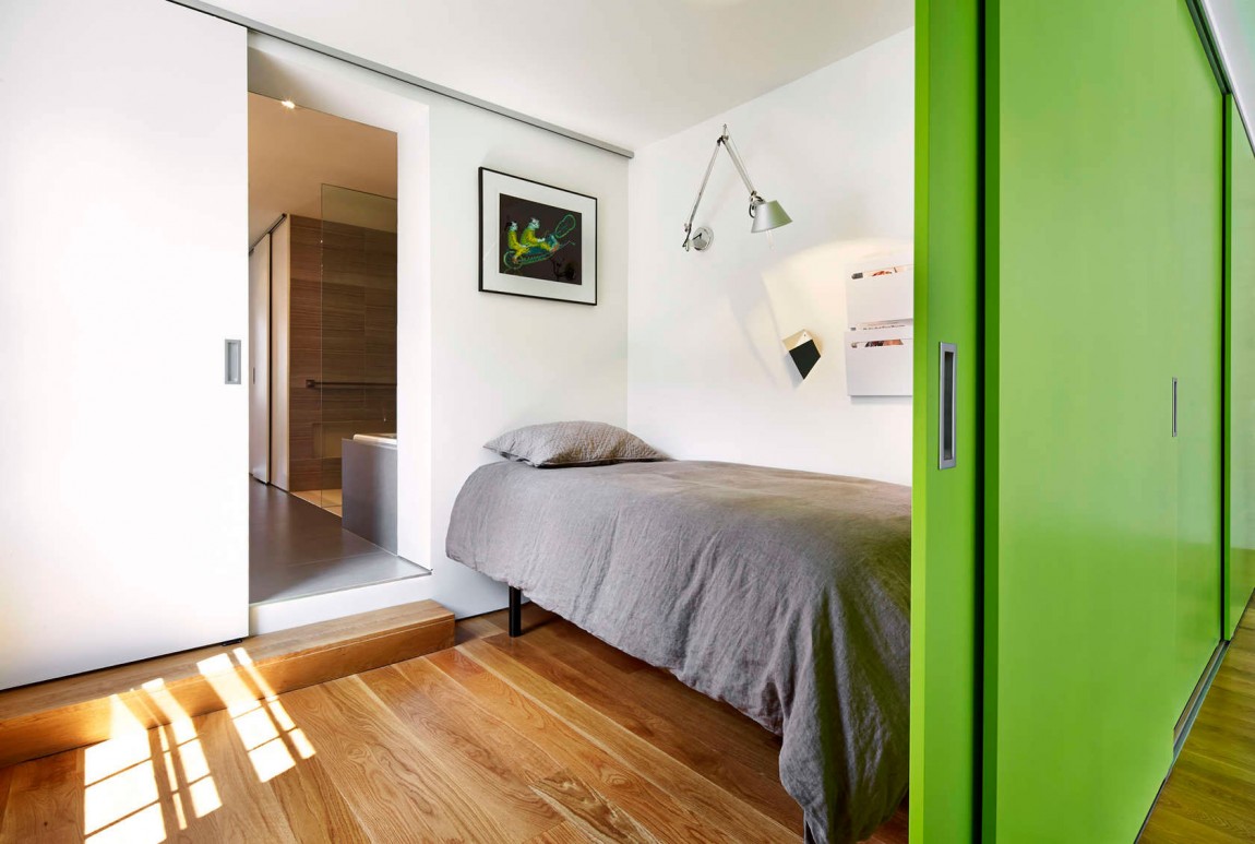 Sleeping nook and guest room on top level with sliding green doors