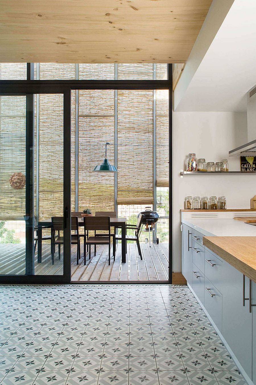 Sliding glass doors between the kitchen and the dining on the deck