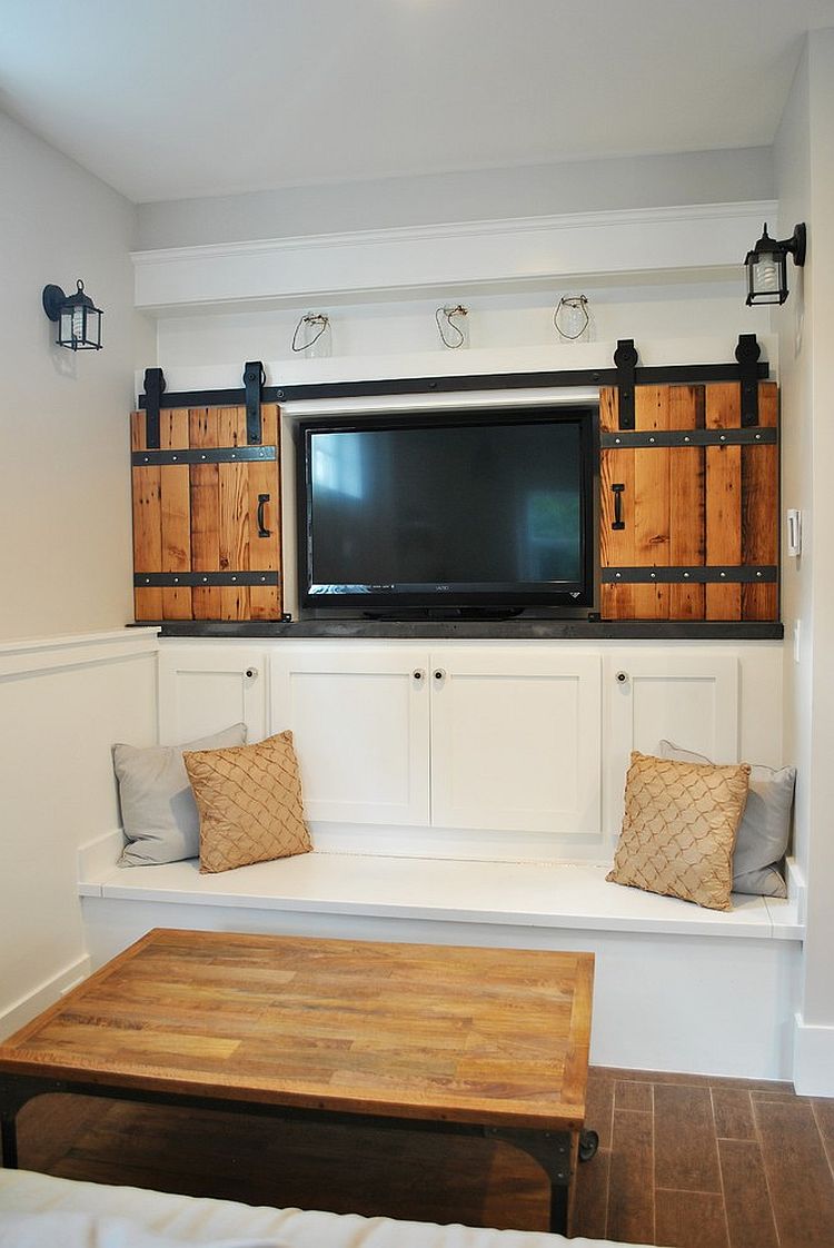 Small living room with sliding barn-style doors for the television nook [Design: 12th Ave Homes]