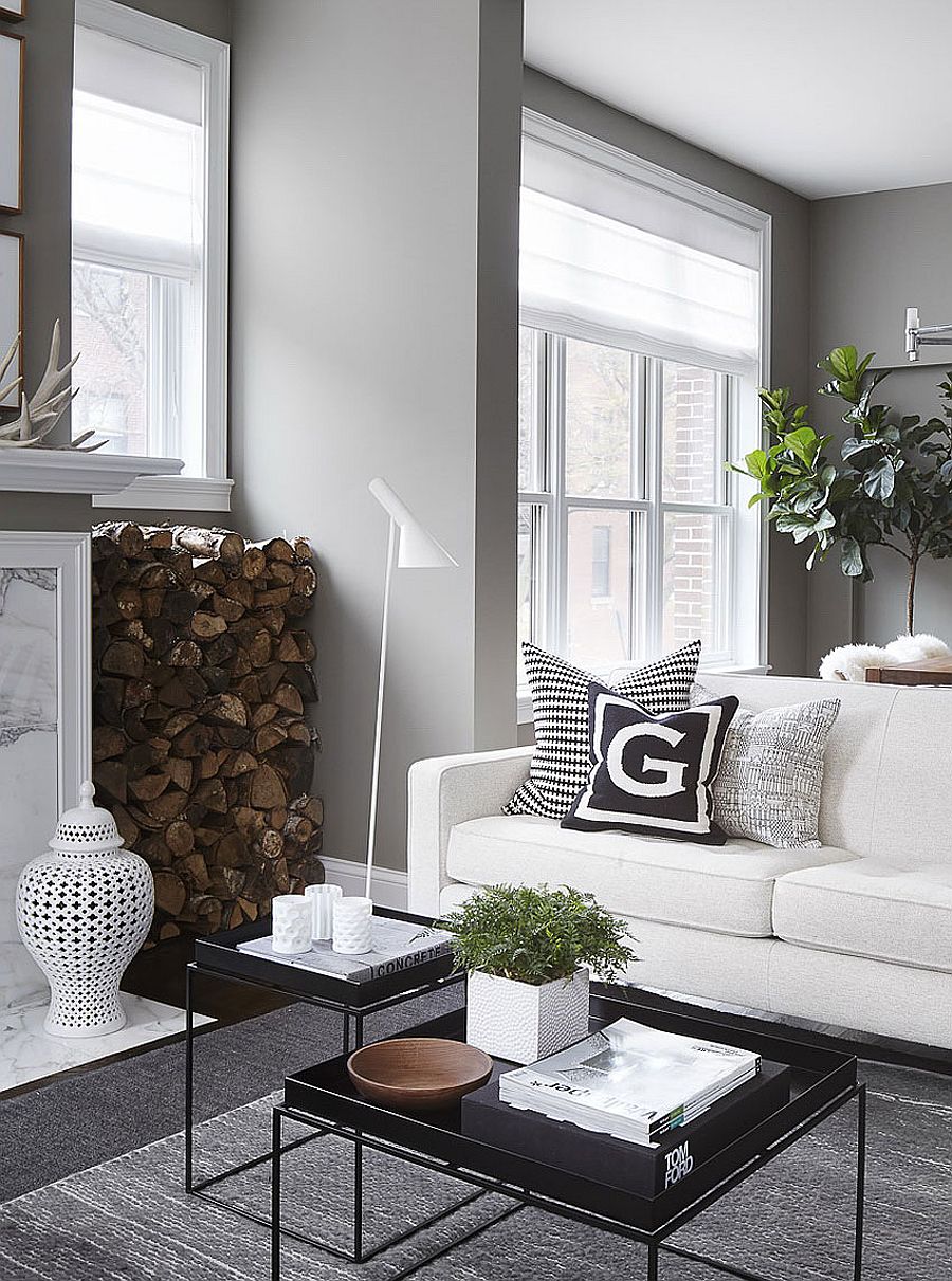 Stacked fireplace next to the fireplace adds textural beauty to the posh living room