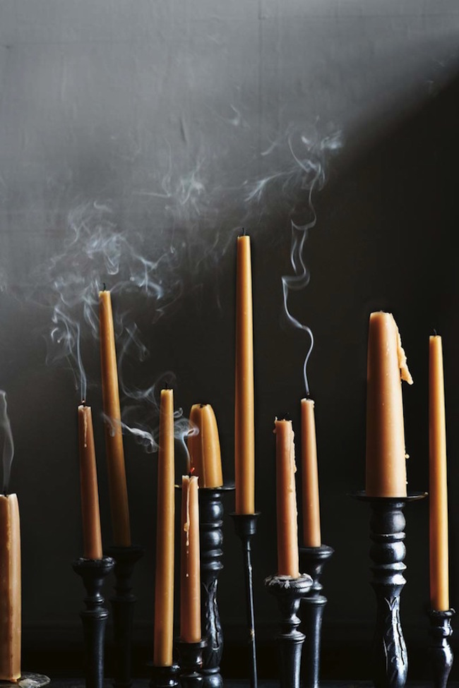 Tall black candlesticks with orange candles