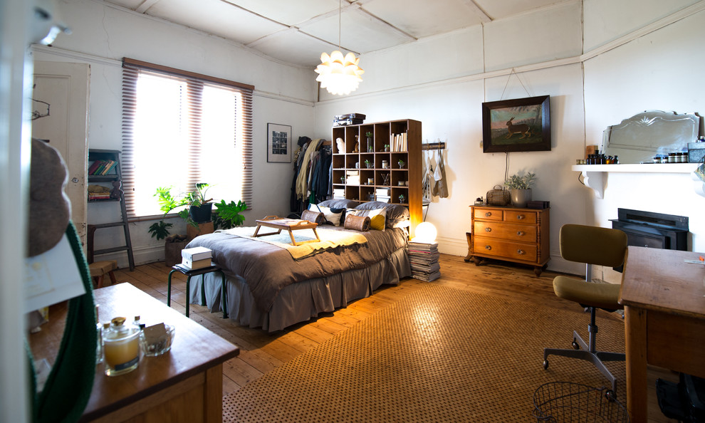 Tall wood bookshelf used as a headboard