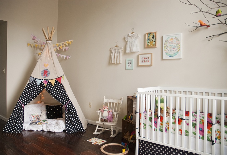 Teepee in nursery with fabric that matches the crib