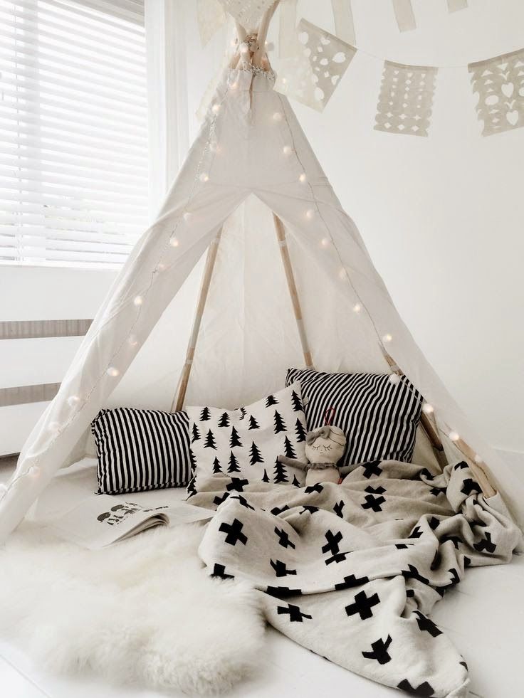 Teepee reading nook with clean colors, patterns, and lantern lights