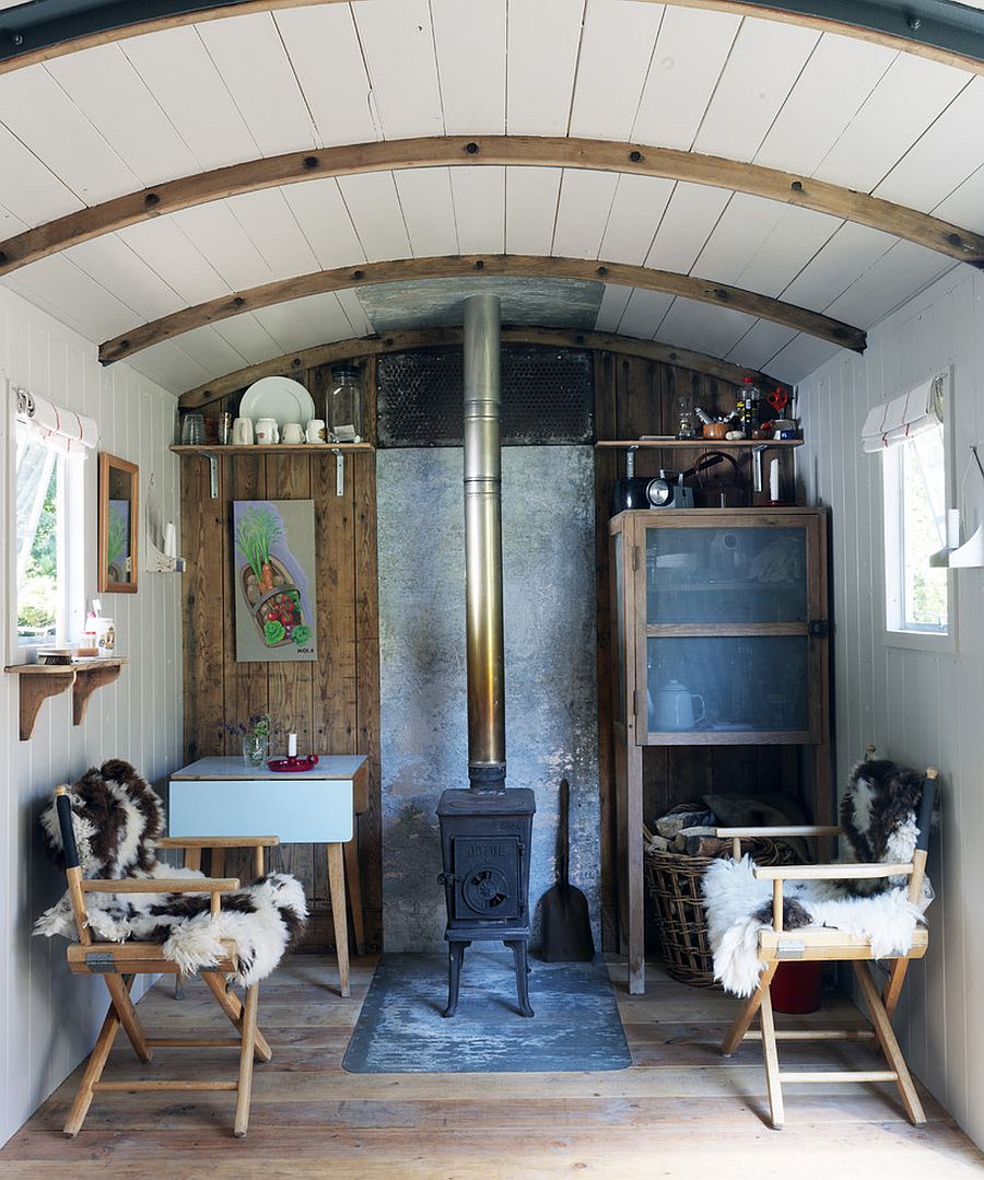 Tiny living room of refurbished railway wagon home [Design: Ryland Peters & Small - CICO Books]