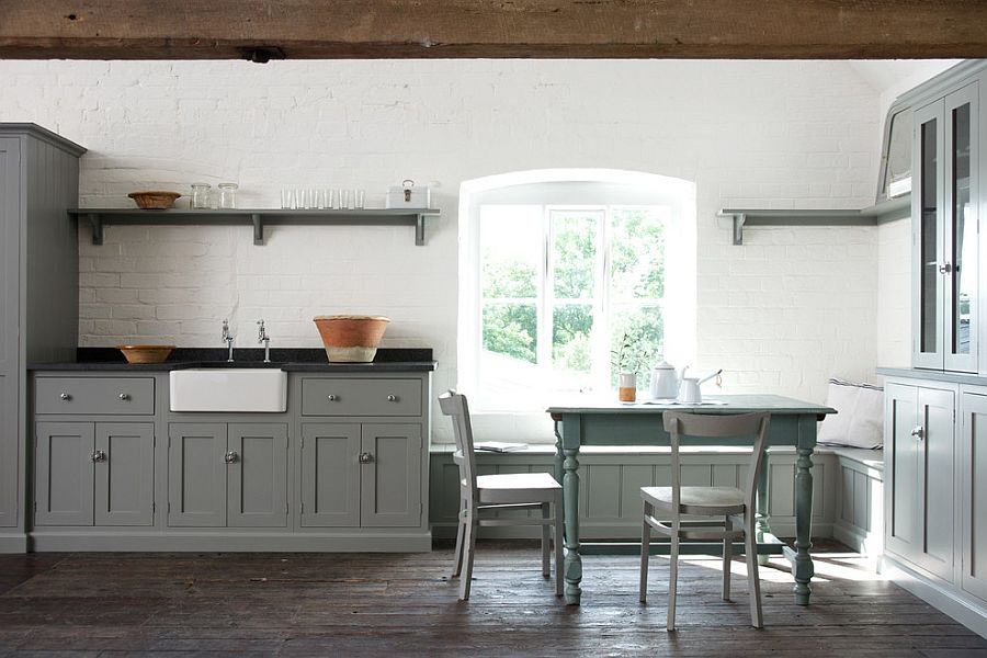 Unassuming kitchen with gray cabinets and a whitewashed brick wall [Design: deVOL Kitchens]