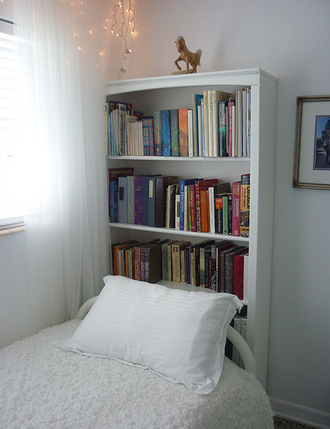 Use a bookshelf as a headboard for small rooms