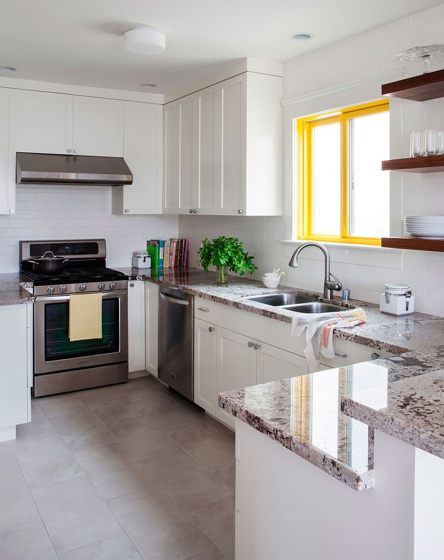 WIndow frame adds a bright spark of yellow to the white kitchen with stone countertops
