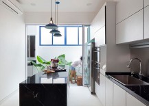 White-and-bright-modern-kitchen-with-dark-central-island-and-worktops-in-stone-217x155