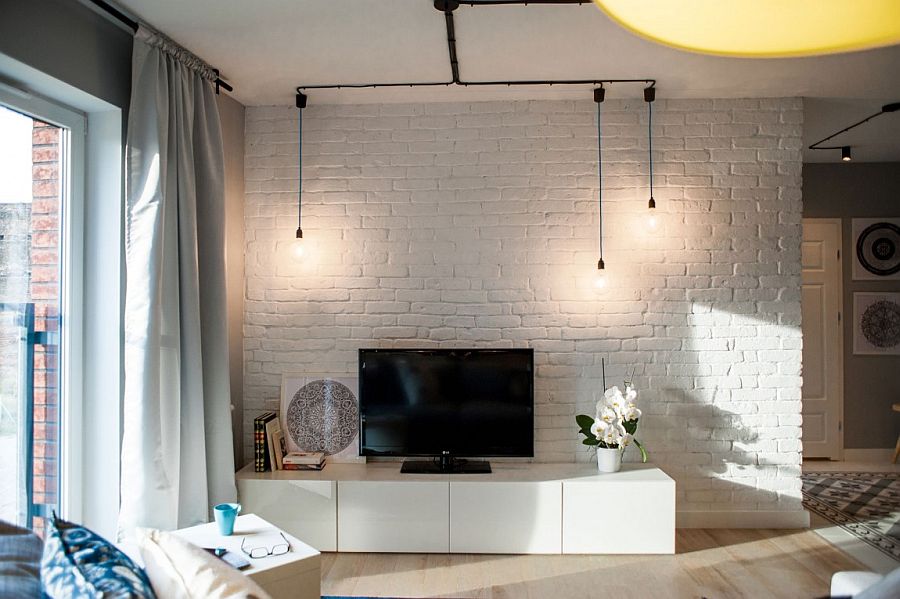 Whitewashed brick wall in the living and minimal industrial lighting