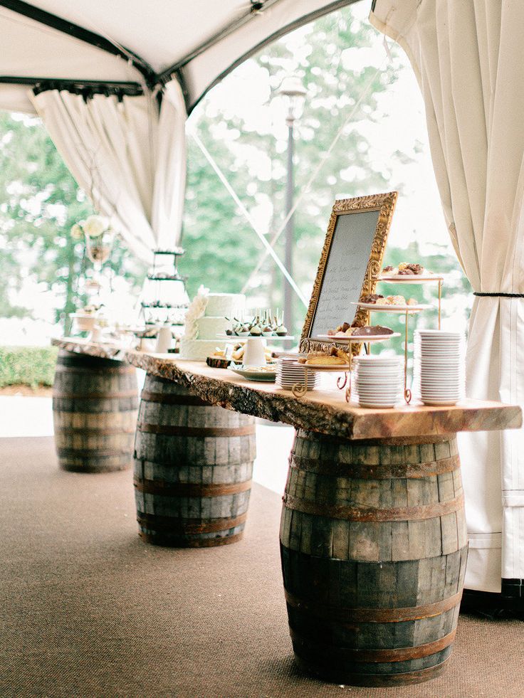 Wine barrels used to hold up the dessert table at a wedding