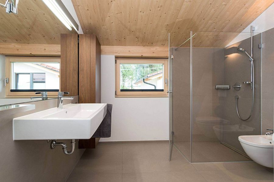 Wooden ceiling adds warmth to the contemporary bath